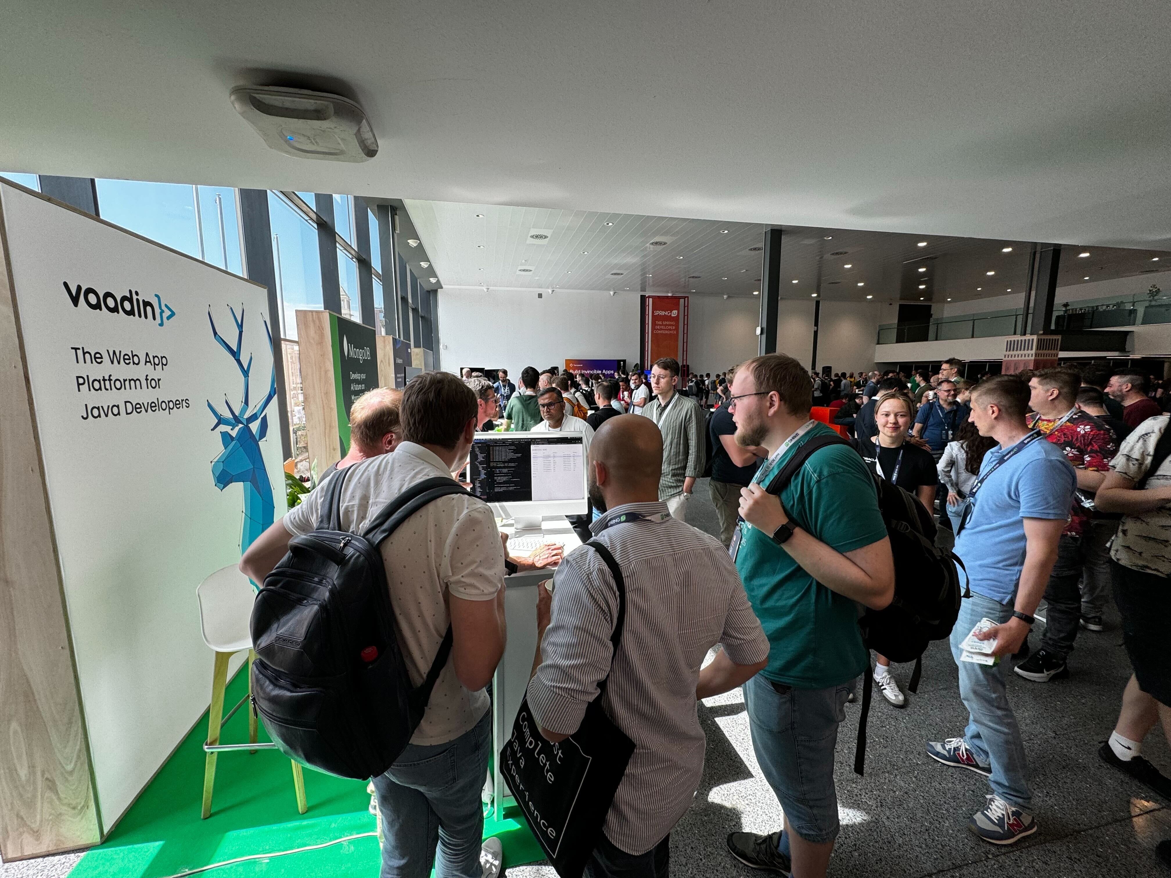 Developers gathered around the Vaadin booth at a conference.